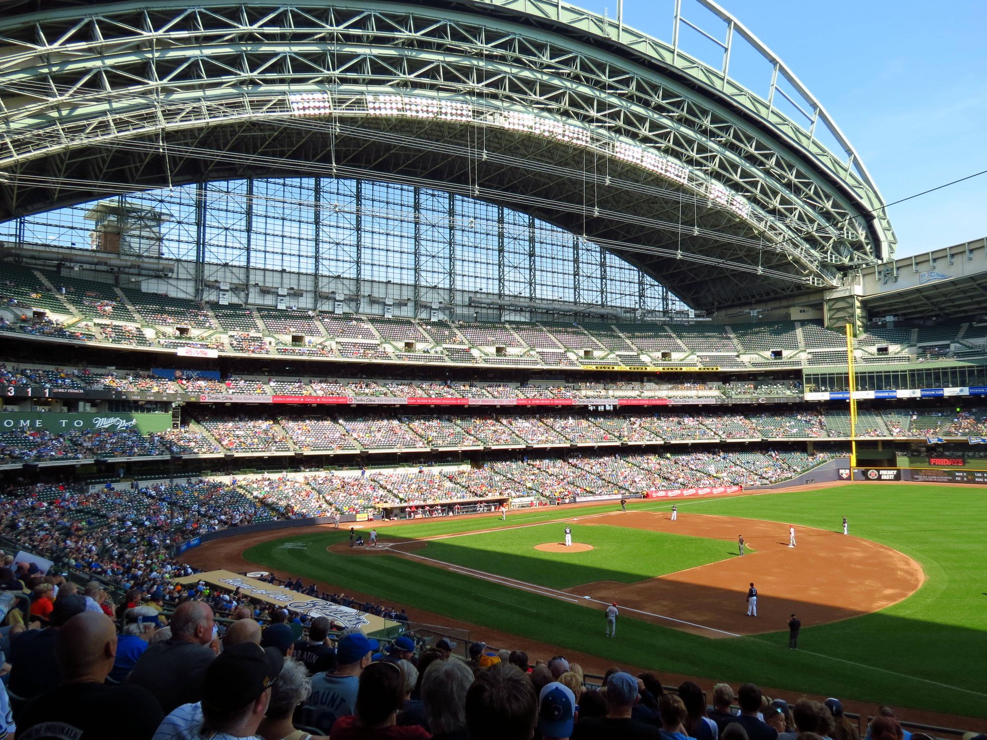 The field at American Family Field from the lower seats during a game, with the roof open