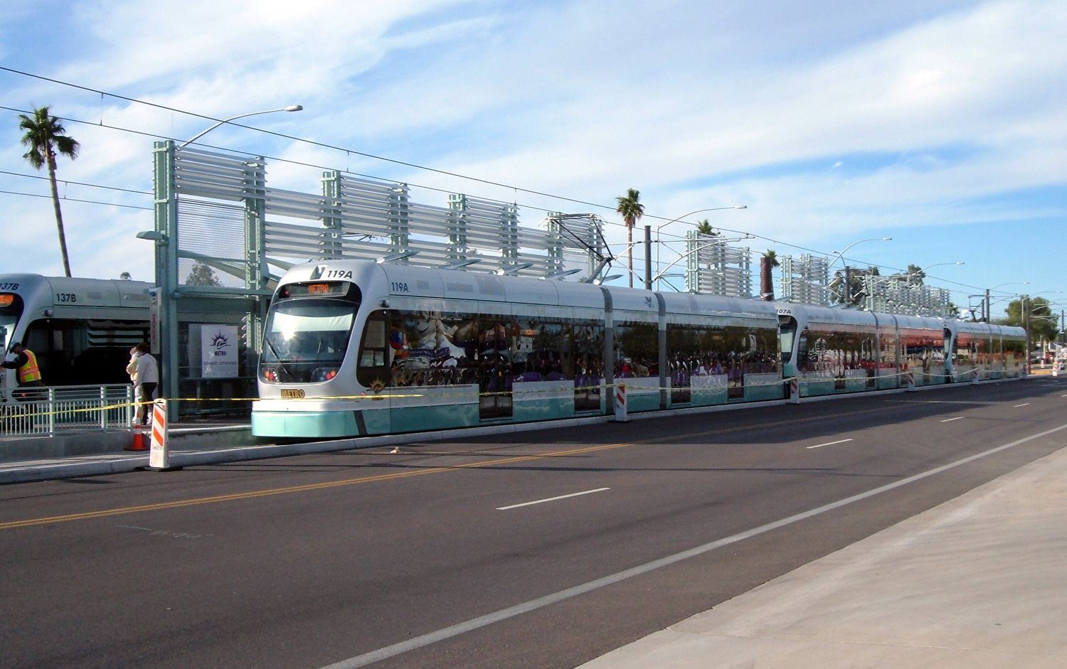 A Valley Metro light rail train pulling into a station on a sunny day