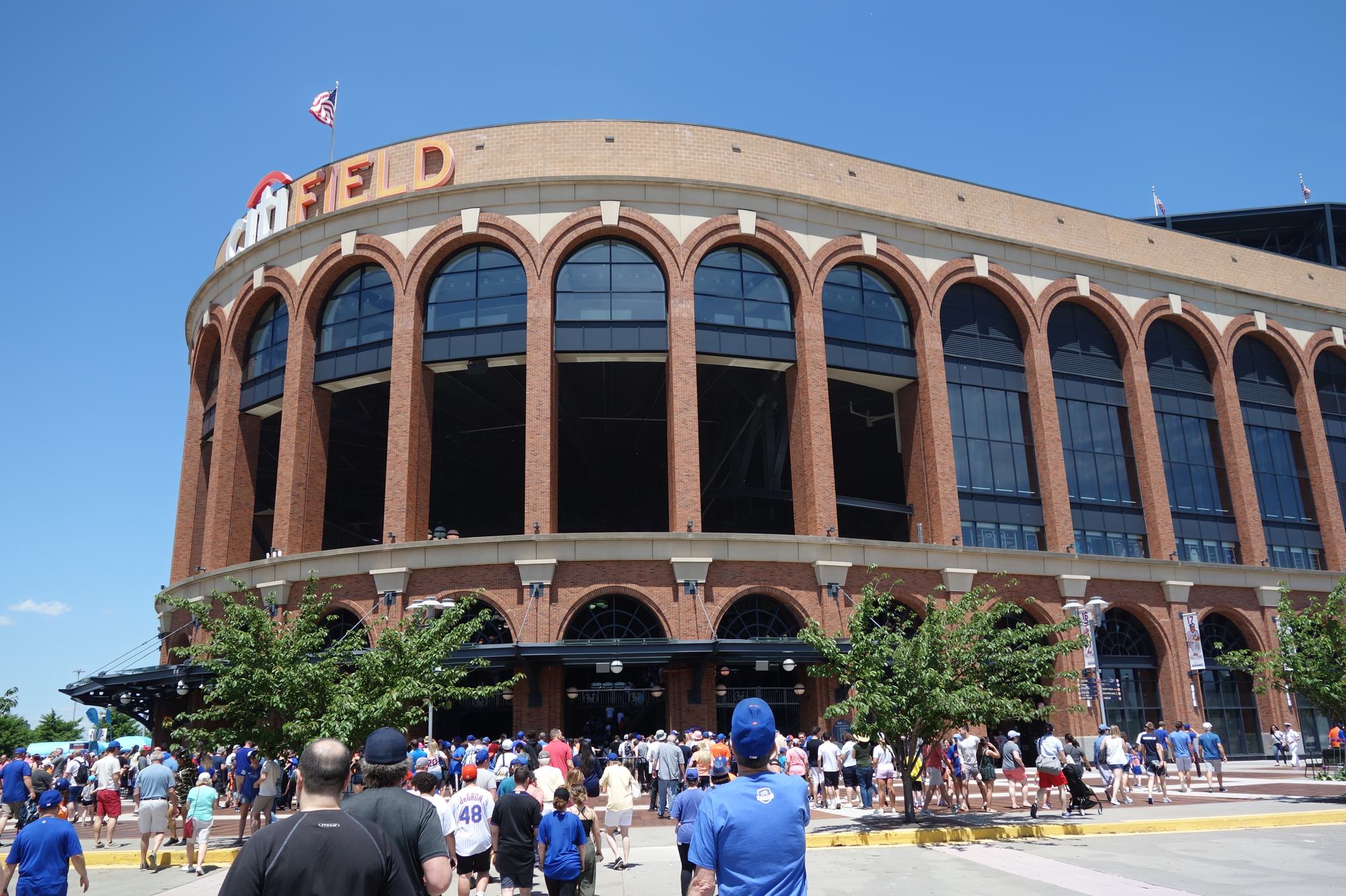 The brick Jackie Robinson Rotunda entrance at Citi Field, with fans gathering outside before a game