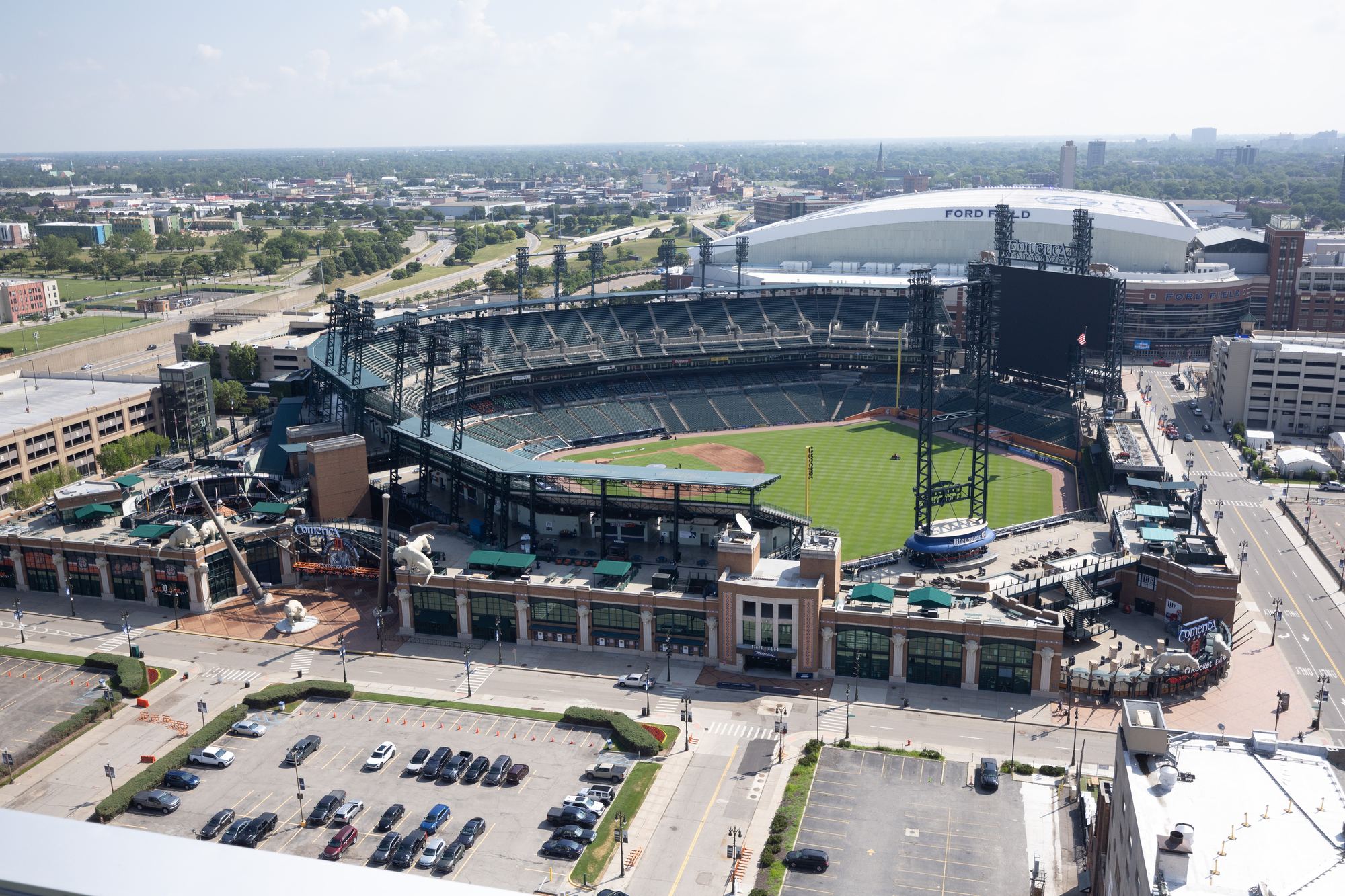 An aerial view of Comerica Park in downtown Detroit on a summer day, with Ford Field next door