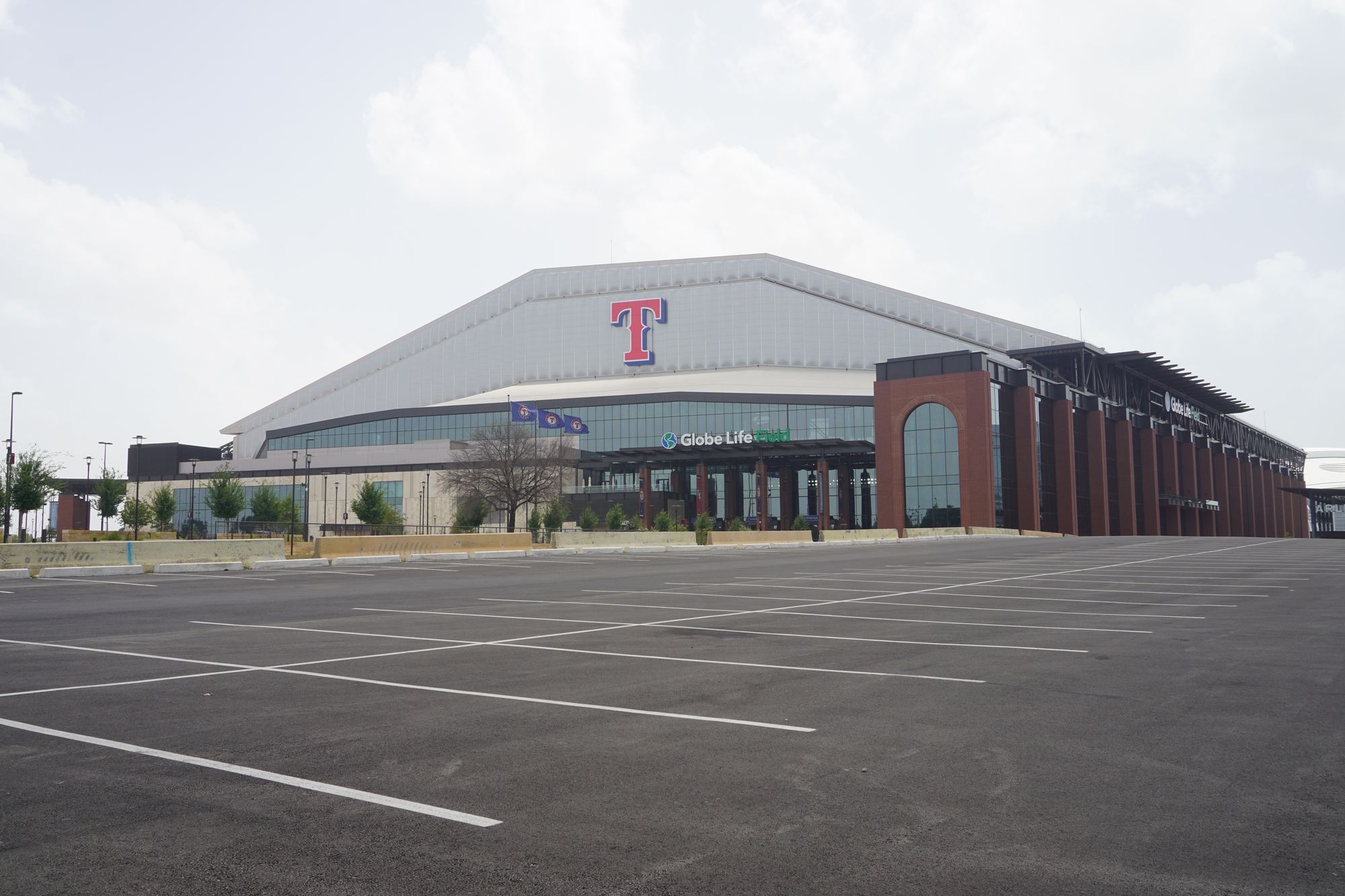 Globe Life Field from across an empty surface parking lot