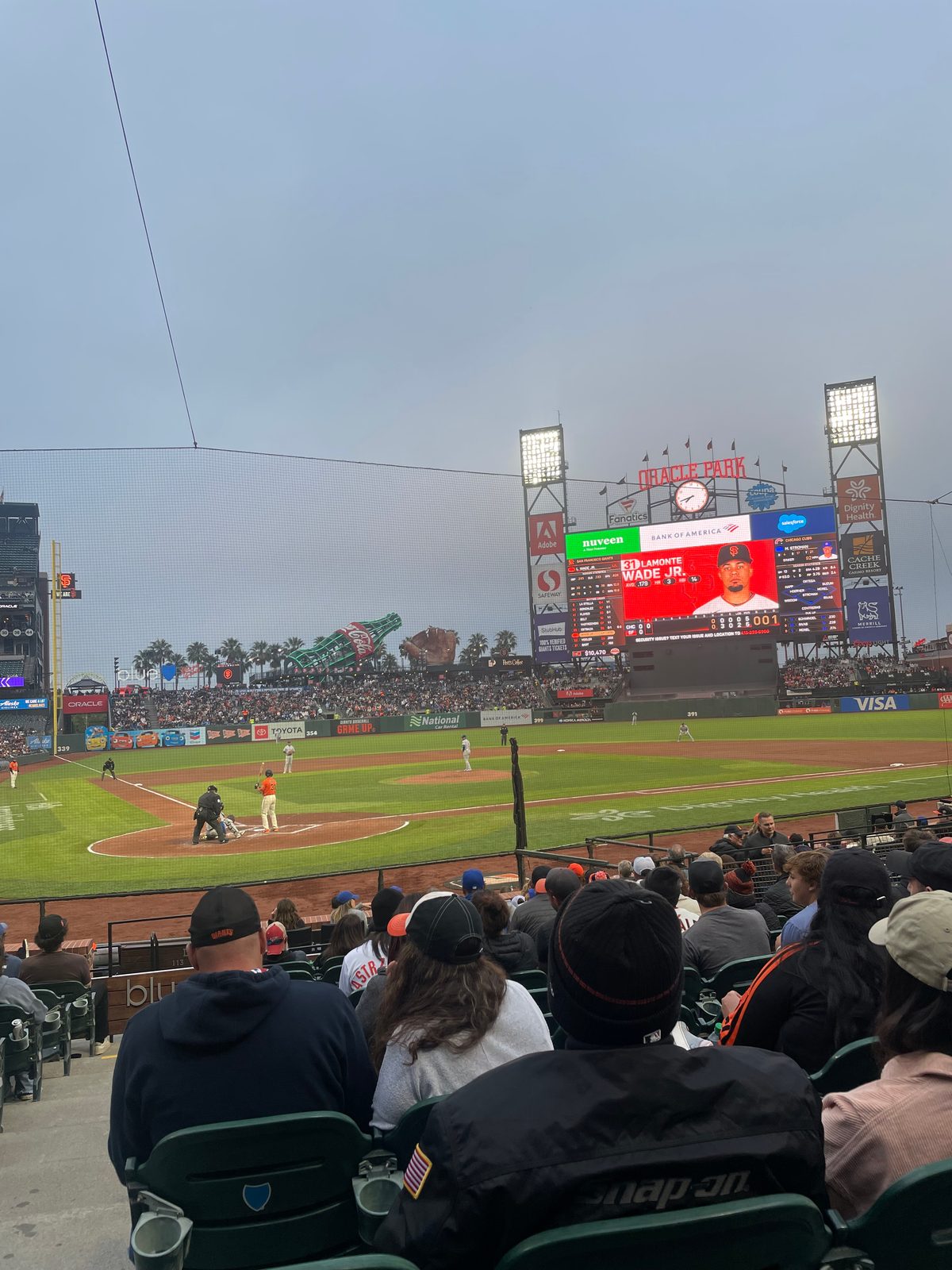 Looking down over the field at Oracle Park from the upper seats on a foggy evening, with the marine layer visible over the ballpark