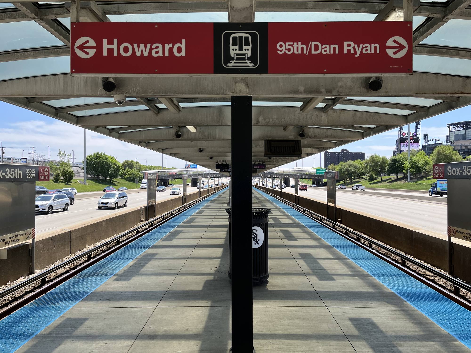 The CTA Red Line Sox-35th station in the Dan Ryan median with the pedestrian bridge leading toward Rate Field