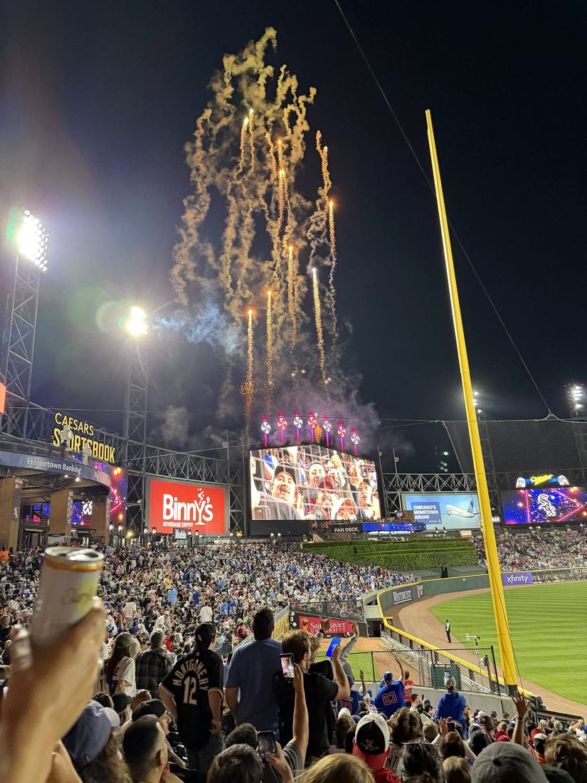 Pinwheels and fireworks on the Rate Field center field scoreboard at night