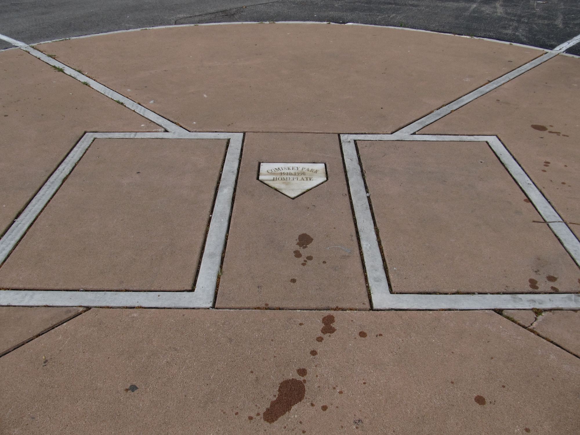 The marker for old Comiskey Park's home plate, set in the pavement just north of Rate Field, with the batter's boxes outlined around it