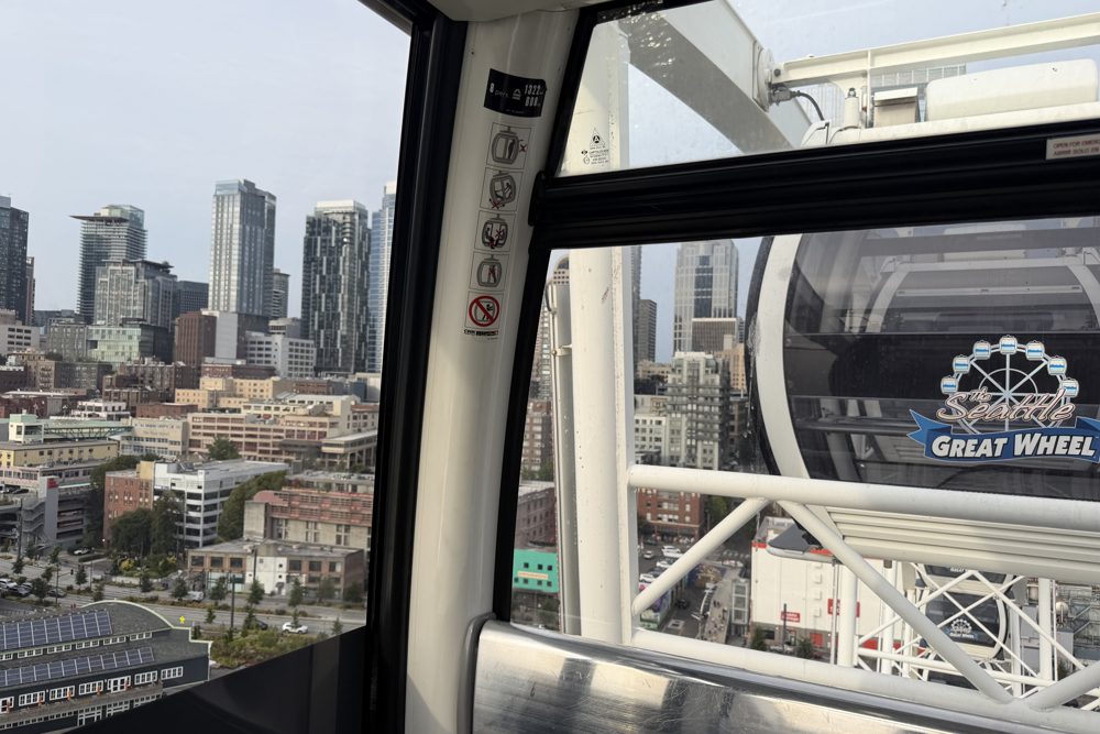 The downtown Seattle skyline seen through the window of a Seattle Great Wheel gondola on the waterfront