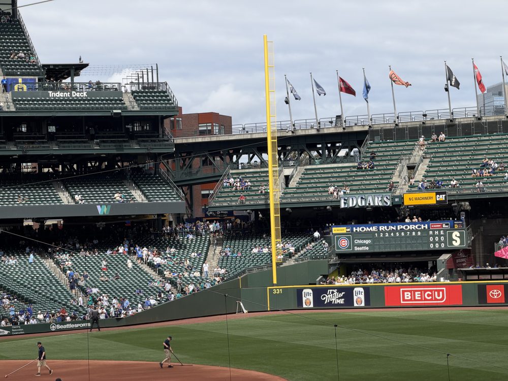 The left field seats at T-Mobile Park, with the yellow foul pole, the Home Run Porch scoreboard, Edgar's signage, and the Trident Deck up top