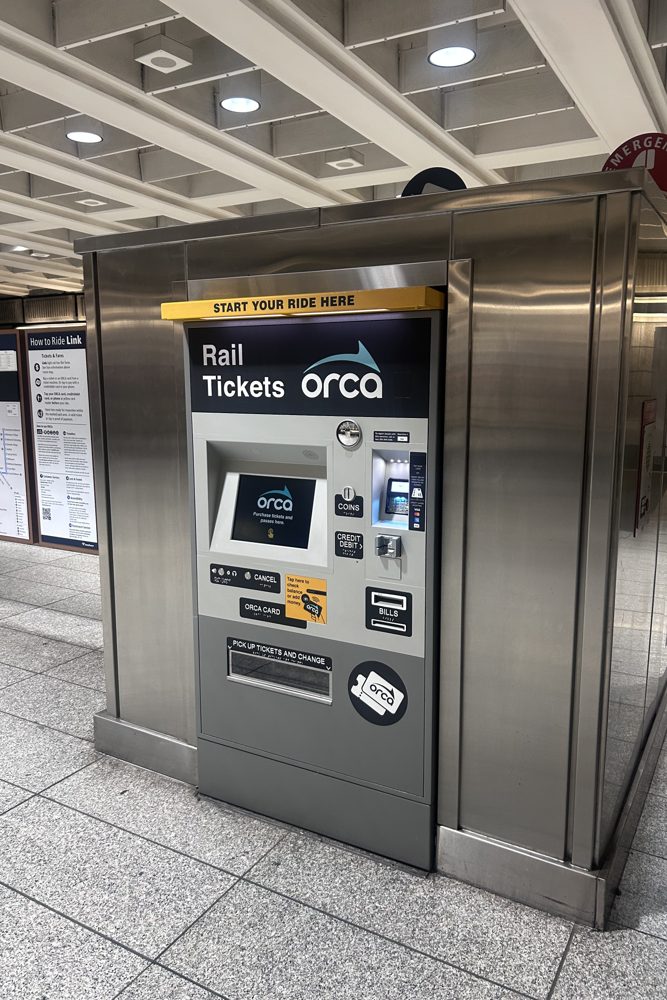 A Rail Tickets ORCA vending machine with a Start Your Ride Here header inside a Seattle Link light rail station