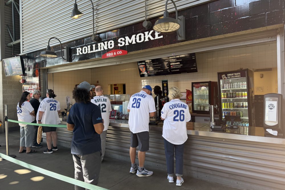 Fans in line at the Rolling Smoke BBQ and Co. stand at T-Mobile Park