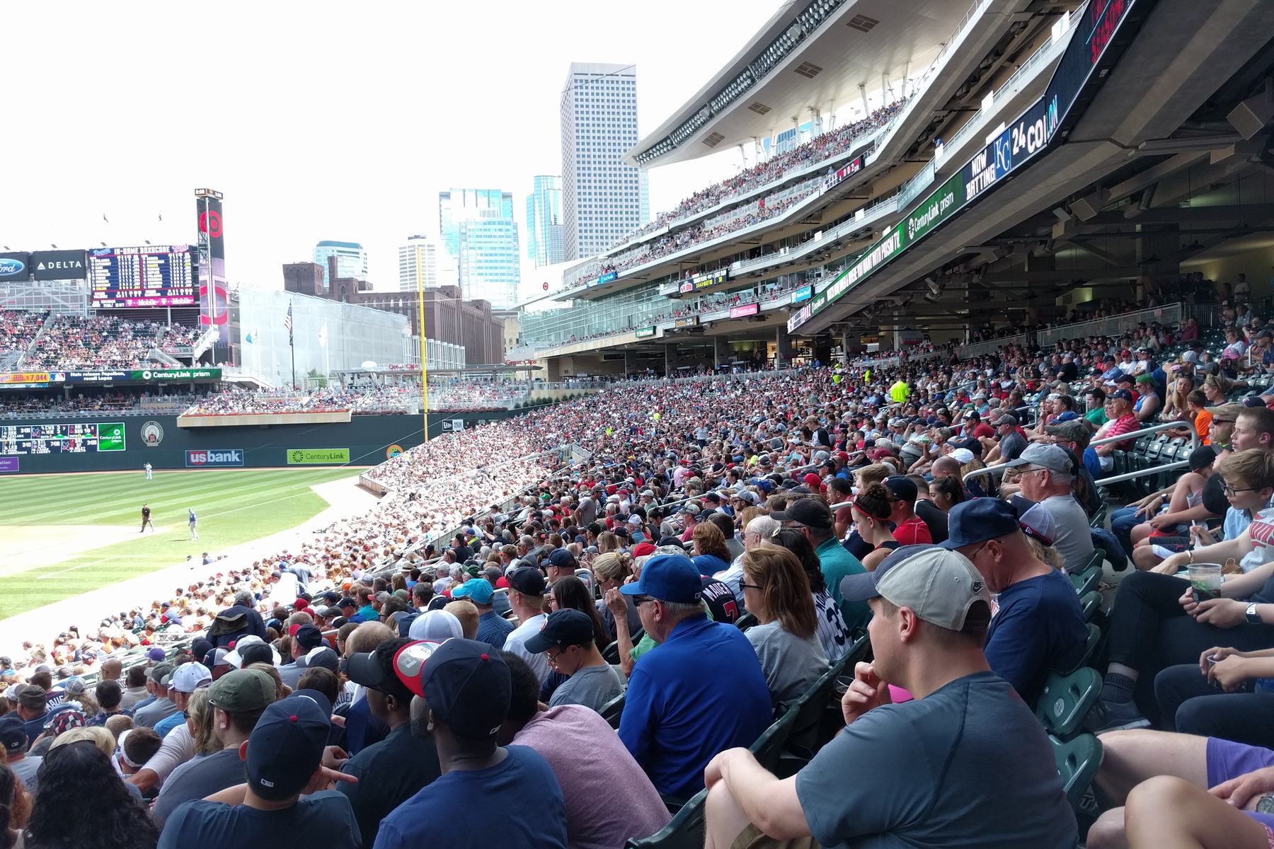 Fans packed into the seats at Target Field on a sunny afternoon, the field and the downtown Minneapolis skyline beyond the outfield