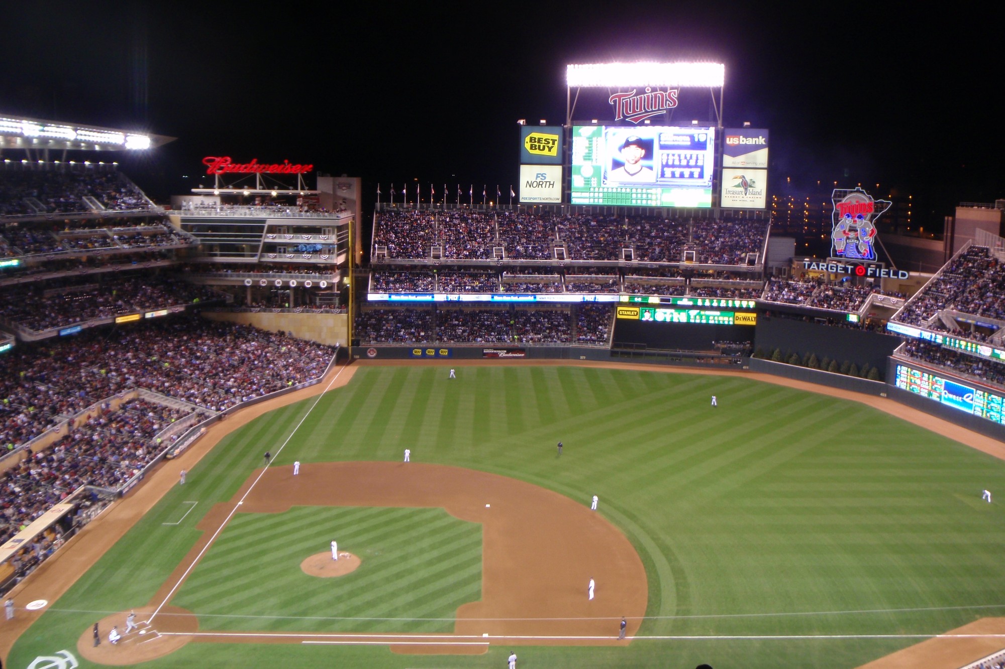 A night game at Target Field, the bowl full and the lights on over the field