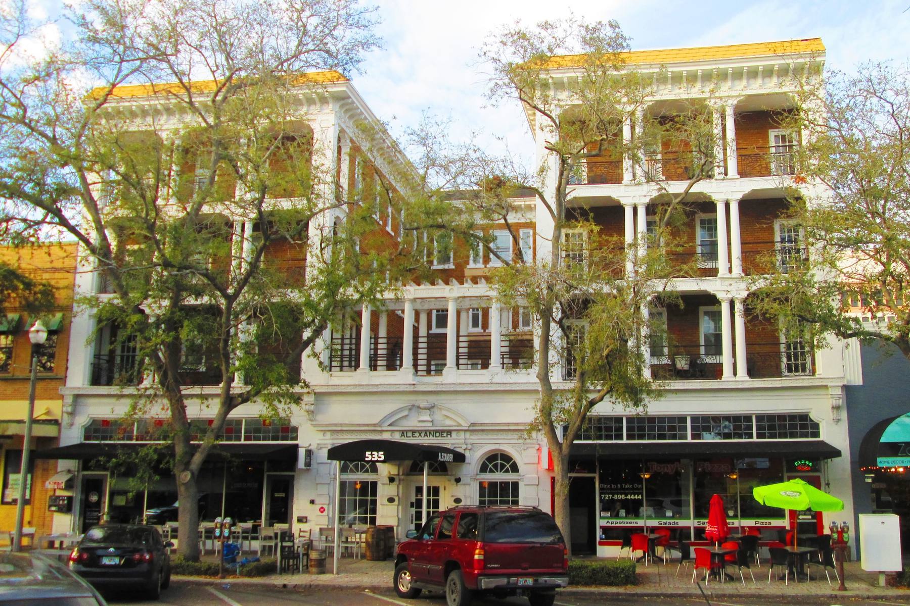 Central Avenue in downtown St. Petersburg, storefronts and awnings along the block beneath the Alexander Hotel