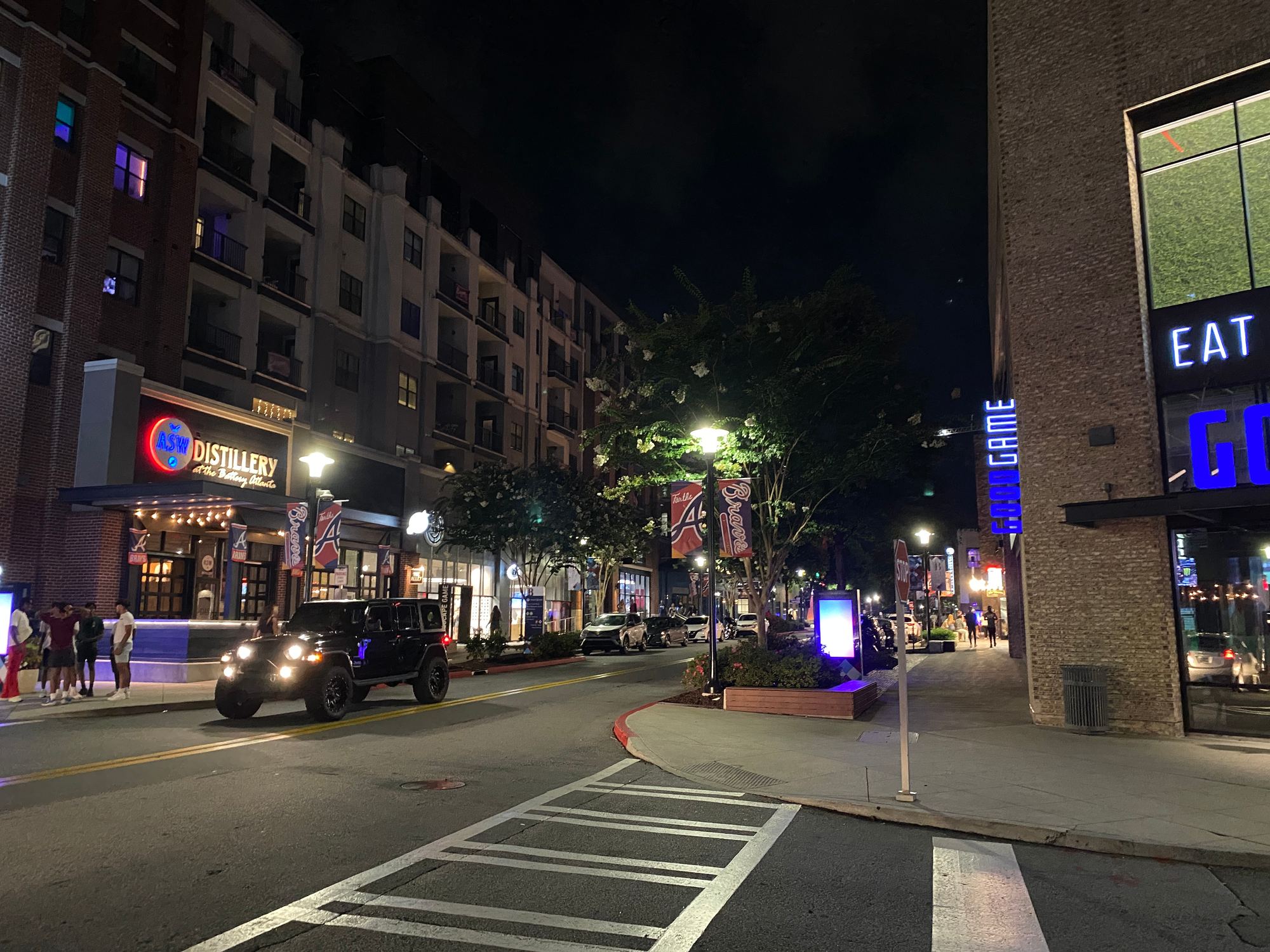The Battery Atlanta entertainment district lit up at night beside Truist Park