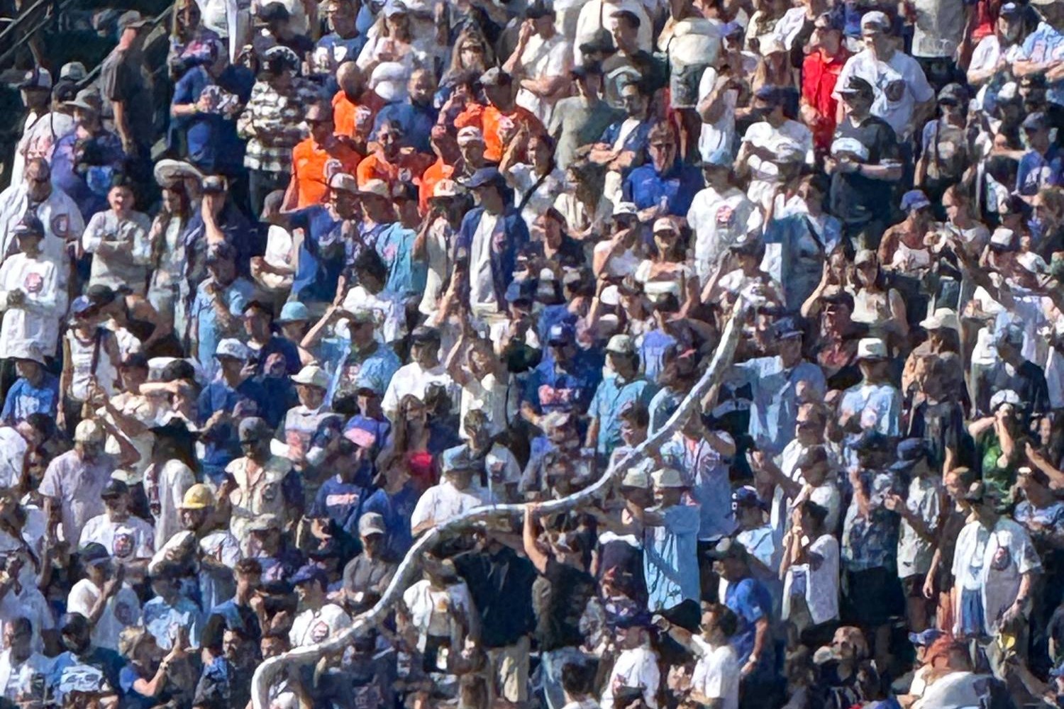 A packed bleacher crowd in Cubs blue at Wrigley Field during a day game